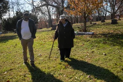 Harry and Janis Ivory walk through the cemetery where their parents are buried in Rendville, OH. Janis, her brother Harry and others are working to revitalize the old coal town.